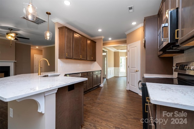 kitchen featuring stove, tasteful backsplash, ceiling fan, decorative light fixtures, and dark hardwood / wood-style flooring