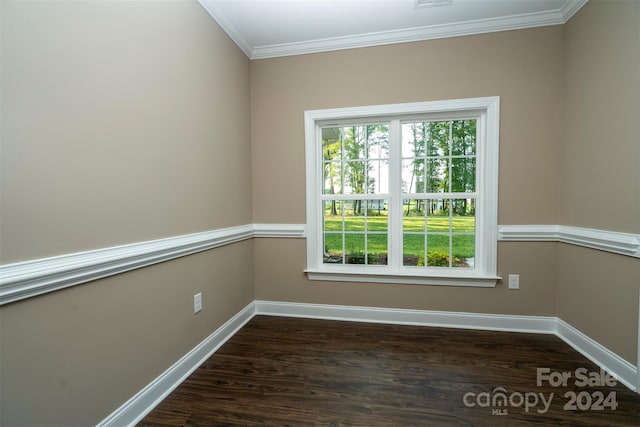 empty room with hardwood / wood-style flooring and crown molding