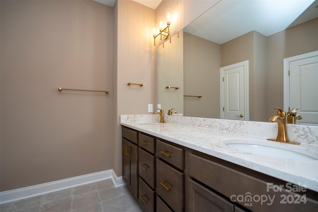 bathroom with tile patterned floors and double sink vanity