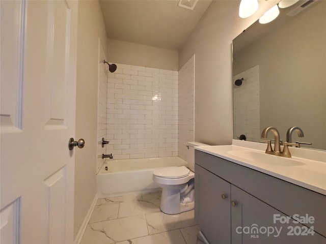 full bathroom with vanity, tiled shower / bath, and toilet