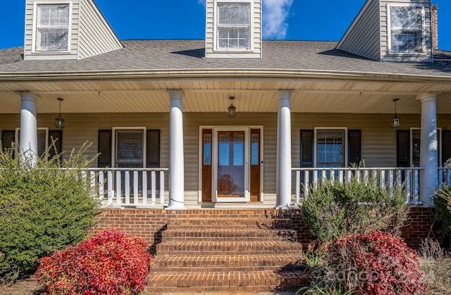 view of exterior entry with covered porch