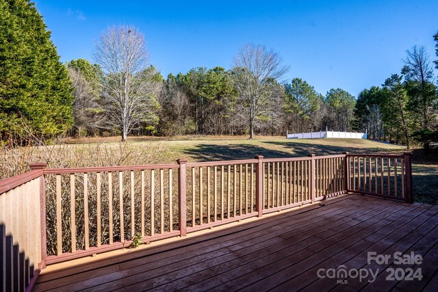 wooden deck featuring a yard