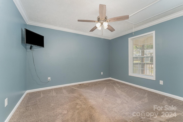 empty room featuring a textured ceiling, ceiling fan, carpet, and ornamental molding