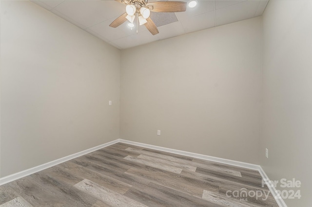 spare room featuring wood-type flooring and ceiling fan