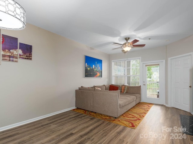 living room featuring ceiling fan and hardwood / wood-style flooring