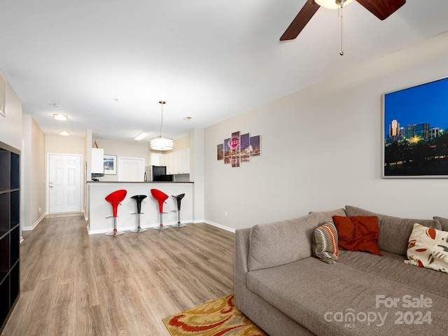 living room with hardwood / wood-style floors and ceiling fan