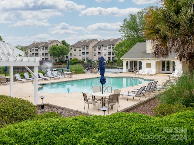 view of swimming pool featuring a pergola and a patio