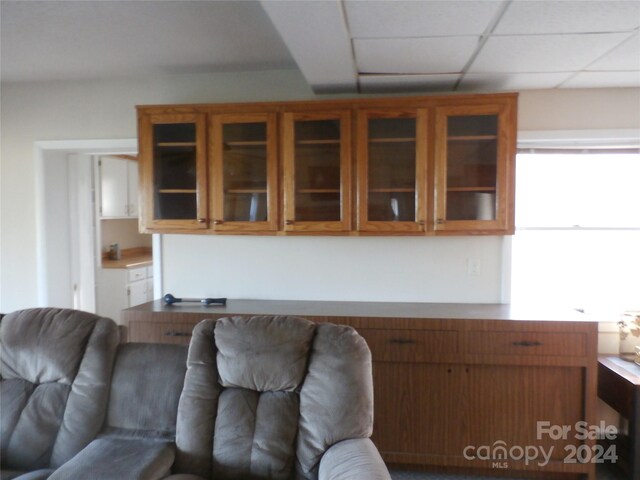 living room featuring a drop ceiling