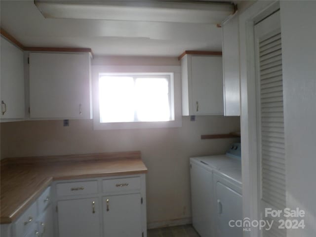 washroom featuring cabinets and independent washer and dryer