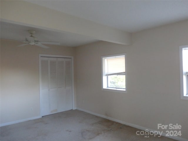 unfurnished bedroom featuring a closet, ceiling fan, and carpet floors