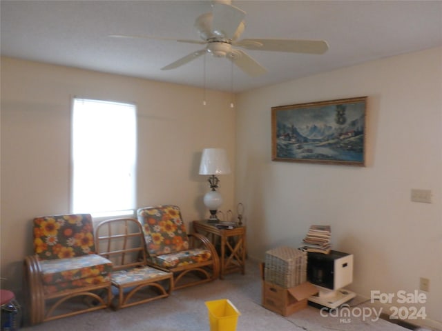 living room with carpet, ceiling fan, and a healthy amount of sunlight