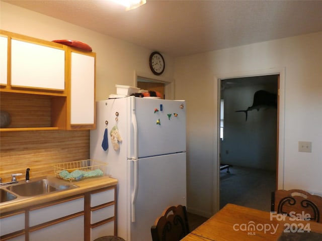 kitchen with sink and white refrigerator