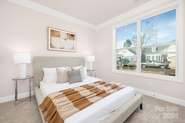 bedroom featuring crown molding and light carpet