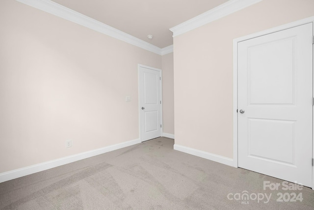 unfurnished bedroom with light colored carpet and ornamental molding