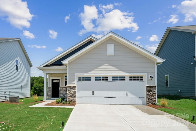 craftsman-style home featuring central AC, a garage, and a front lawn