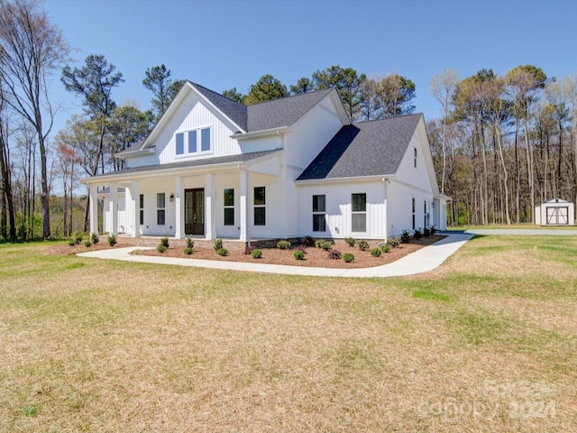 modern inspired farmhouse with a front lawn, a storage unit, and a porch