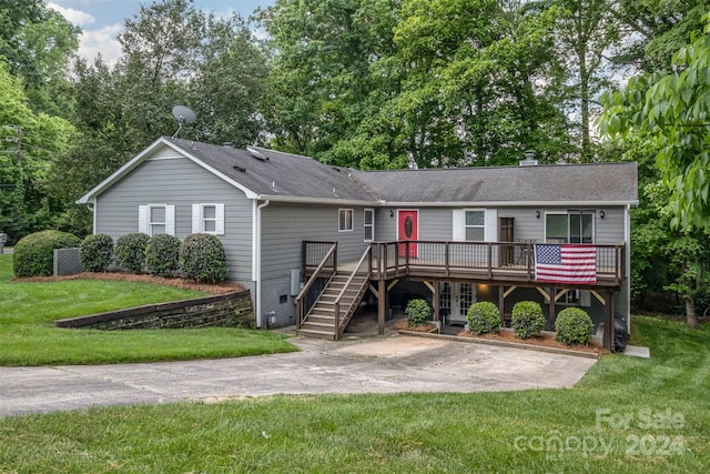 view of front of house featuring a front yard and a wooden deck