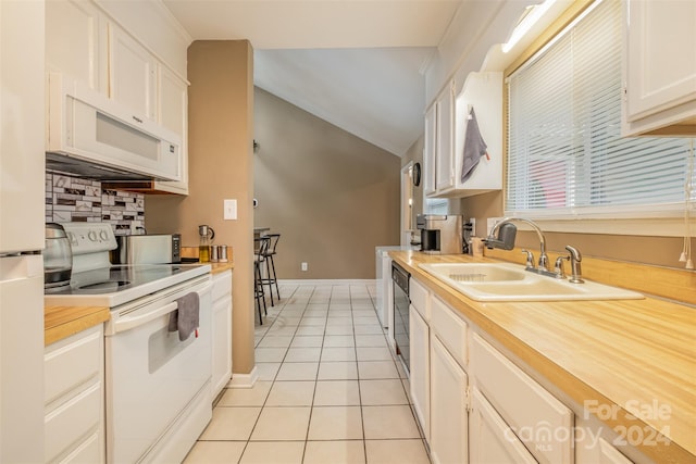 kitchen featuring light tile floors, sink, white appliances, tasteful backsplash, and white cabinetry