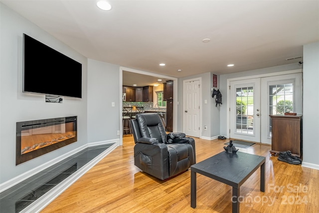 living room with french doors and light hardwood / wood-style floors