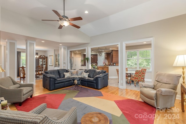 living room featuring vaulted ceiling, ceiling fan, and wood-type flooring