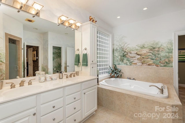 bathroom with plus walk in shower, tile patterned flooring, and vanity