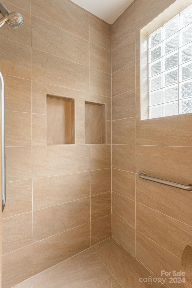 bathroom with tiled shower