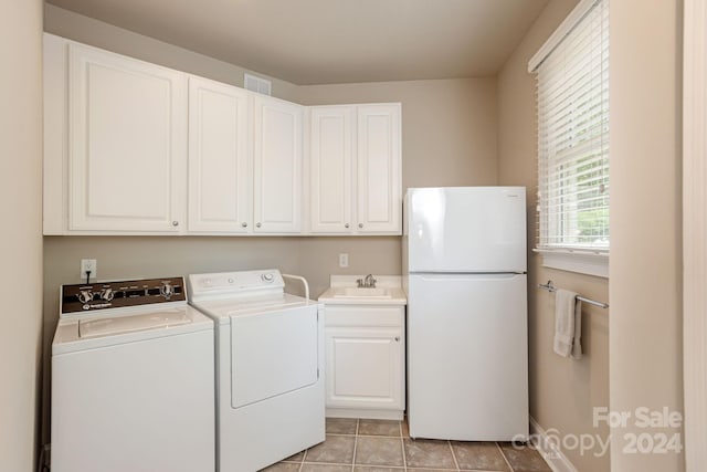 laundry area featuring washer and clothes dryer, sink, and light tile patterned flooring