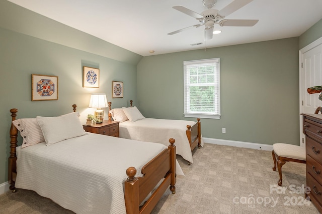 bedroom with ceiling fan, light carpet, and lofted ceiling