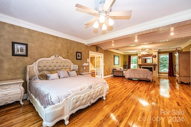 bedroom with wood-type flooring, ceiling fan, and crown molding