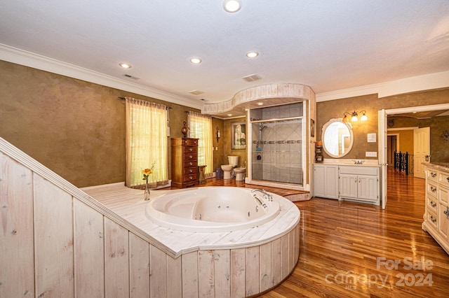 bathroom with ornamental molding, vanity, hardwood / wood-style flooring, and plus walk in shower