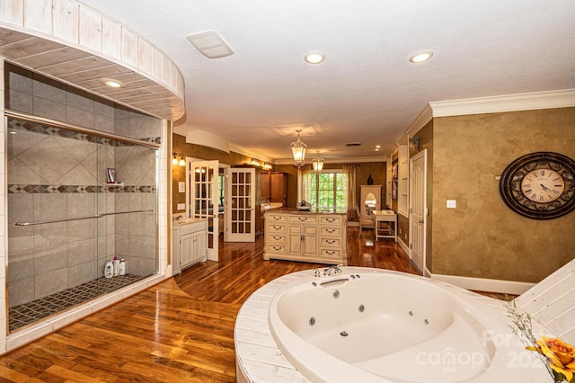 bathroom with ornamental molding, hardwood / wood-style floors, vanity, and shower with separate bathtub