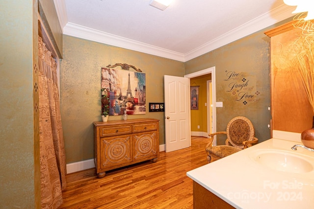 bathroom featuring vanity, hardwood / wood-style flooring, and crown molding