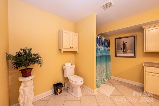 bathroom with vanity, tile floors, and toilet