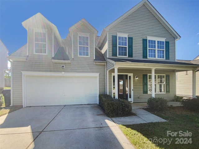 view of front facade with a garage and a porch