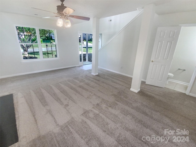 carpeted empty room with ceiling fan