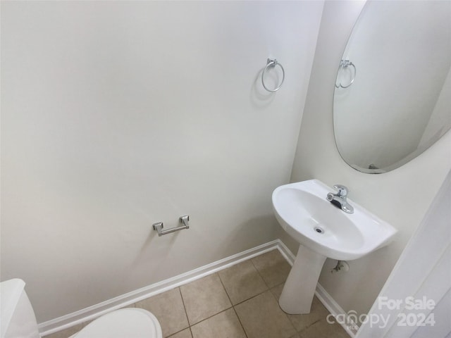 bathroom with tile floors and toilet