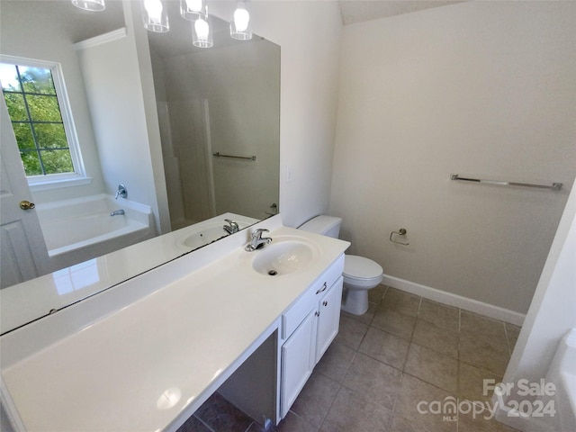 bathroom featuring vanity, tile floors, toilet, and a bath