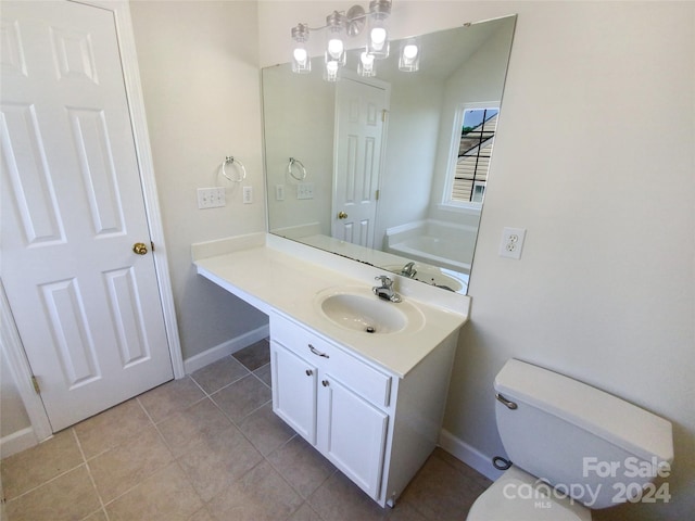 bathroom with toilet, tile flooring, and vanity