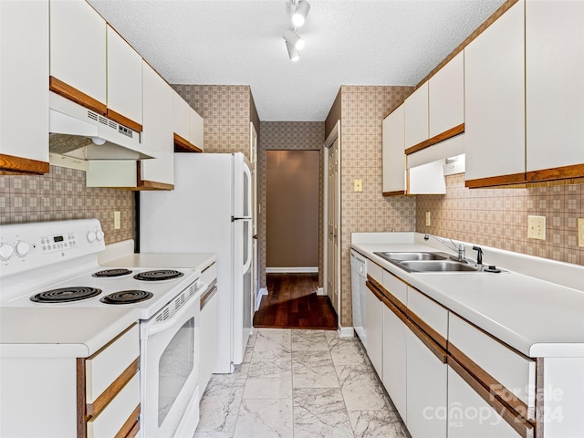 kitchen with white electric range, white cabinetry, track lighting, sink, and a textured ceiling