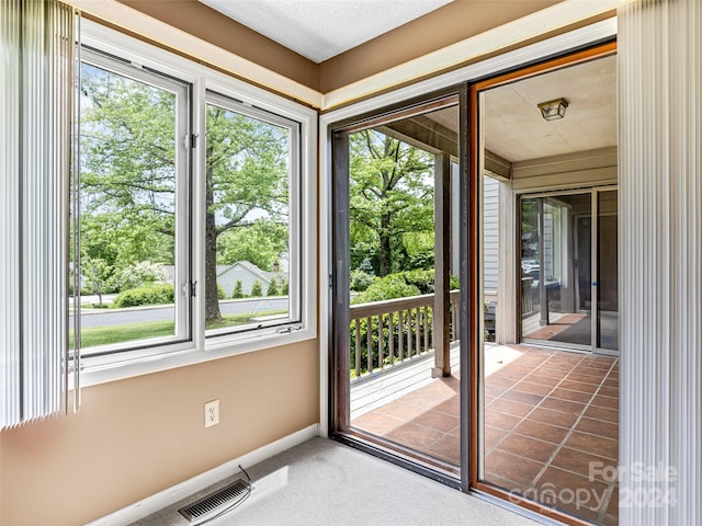 unfurnished sunroom featuring plenty of natural light