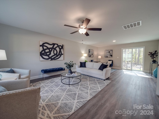 living room featuring wood-type flooring and ceiling fan