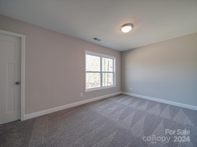 unfurnished room featuring carpet