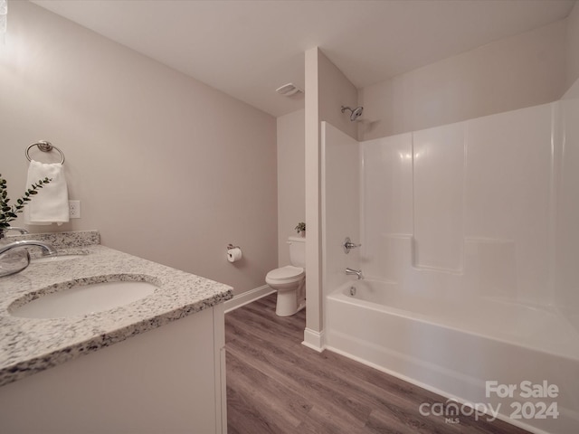 full bathroom featuring bathtub / shower combination, hardwood / wood-style flooring, toilet, and vanity