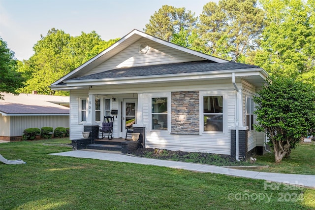 view of front of house featuring a front yard and a porch