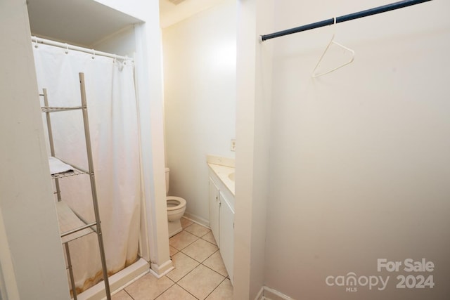 bathroom with toilet, vanity, a shower with shower curtain, and tile patterned flooring