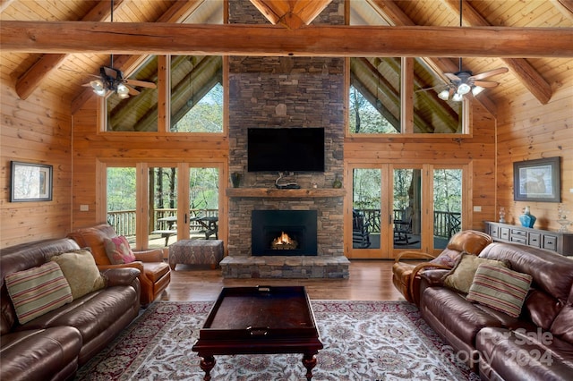 living room featuring wooden walls, hardwood / wood-style floors, and a fireplace