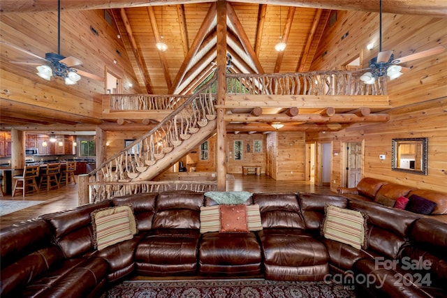 living room featuring high vaulted ceiling, hardwood / wood-style floors, ceiling fan, and wood ceiling