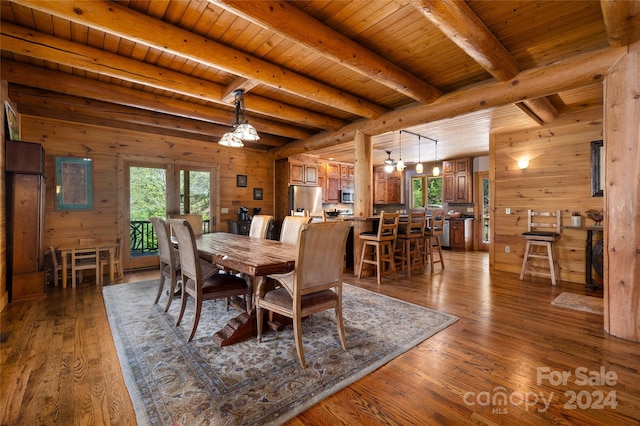 dining room with a healthy amount of sunlight, hardwood / wood-style flooring, and wood ceiling