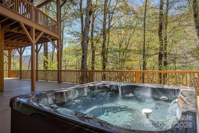 exterior space featuring an outdoor hot tub