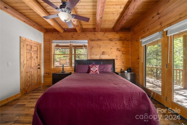 bedroom with dark hardwood / wood-style flooring, multiple windows, access to outside, and beam ceiling